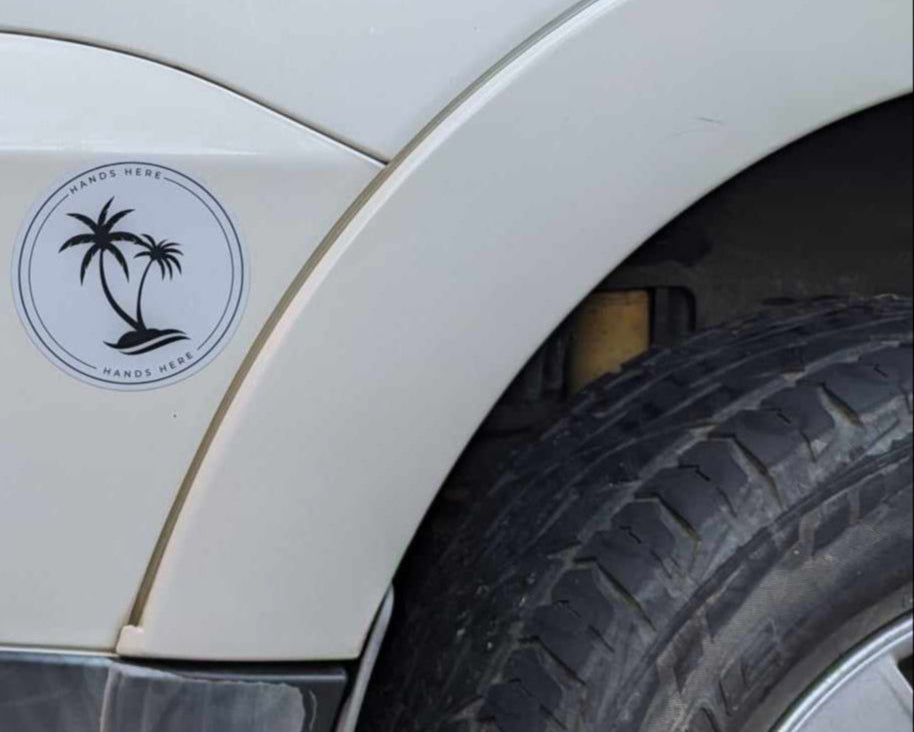 White Palm Decal adhered to white car to top left of wheel arch