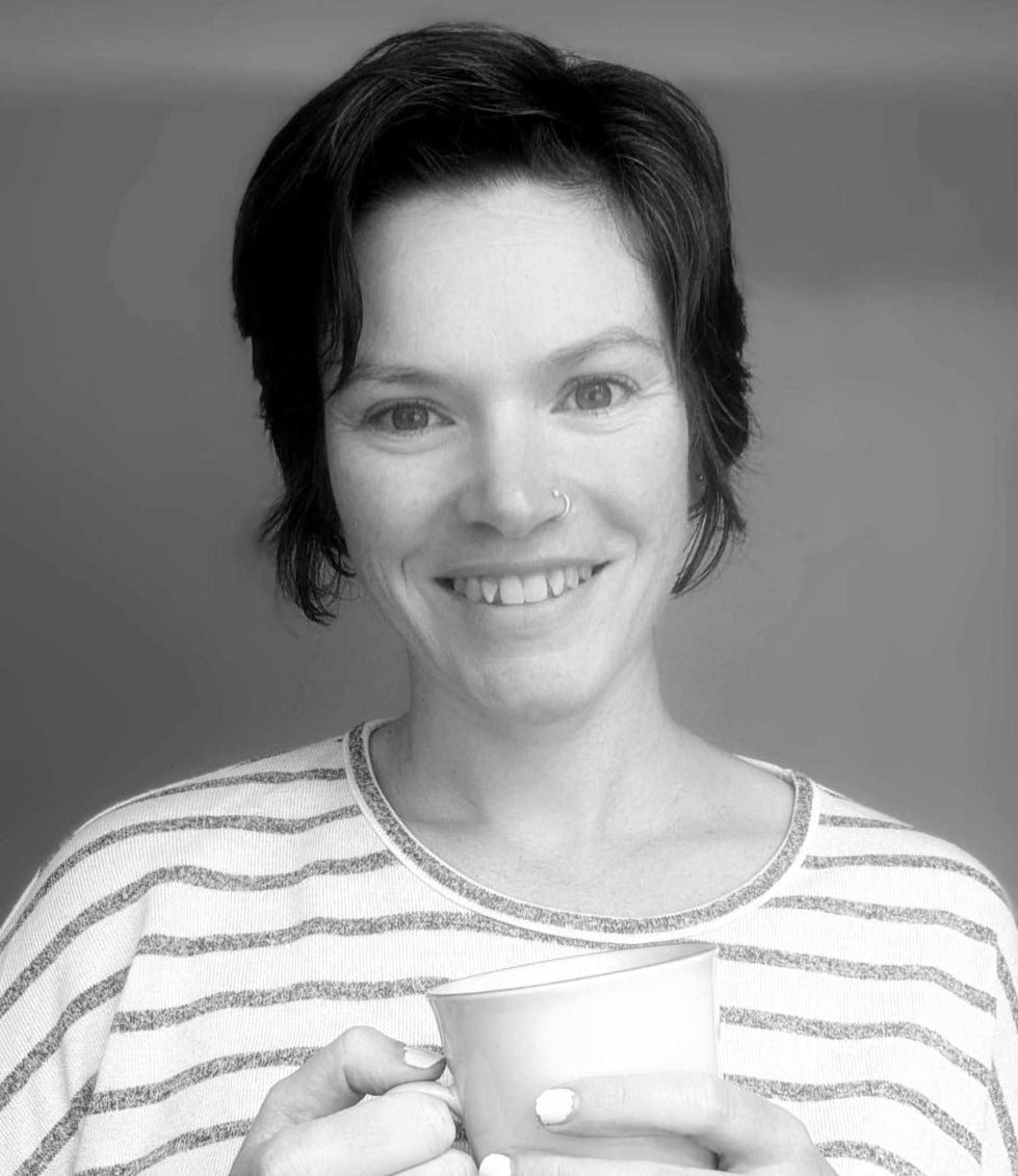 Black and white portrait of founder with soft lighting smiling