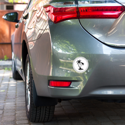 White palm decal or magnet design on rear bumper of grey car showing possible adherence location