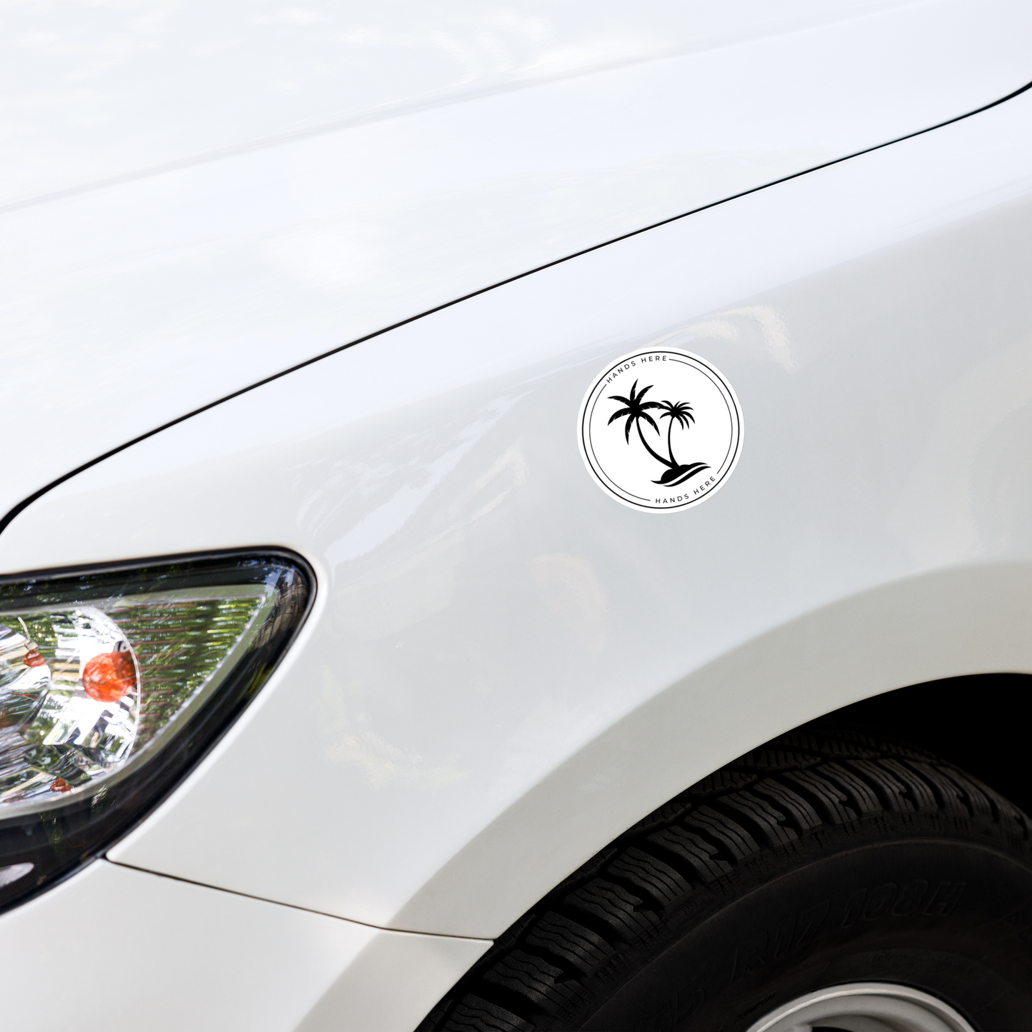 White Hands Here Palm decal or magnet design on front panel of white car showing placement on vehicle